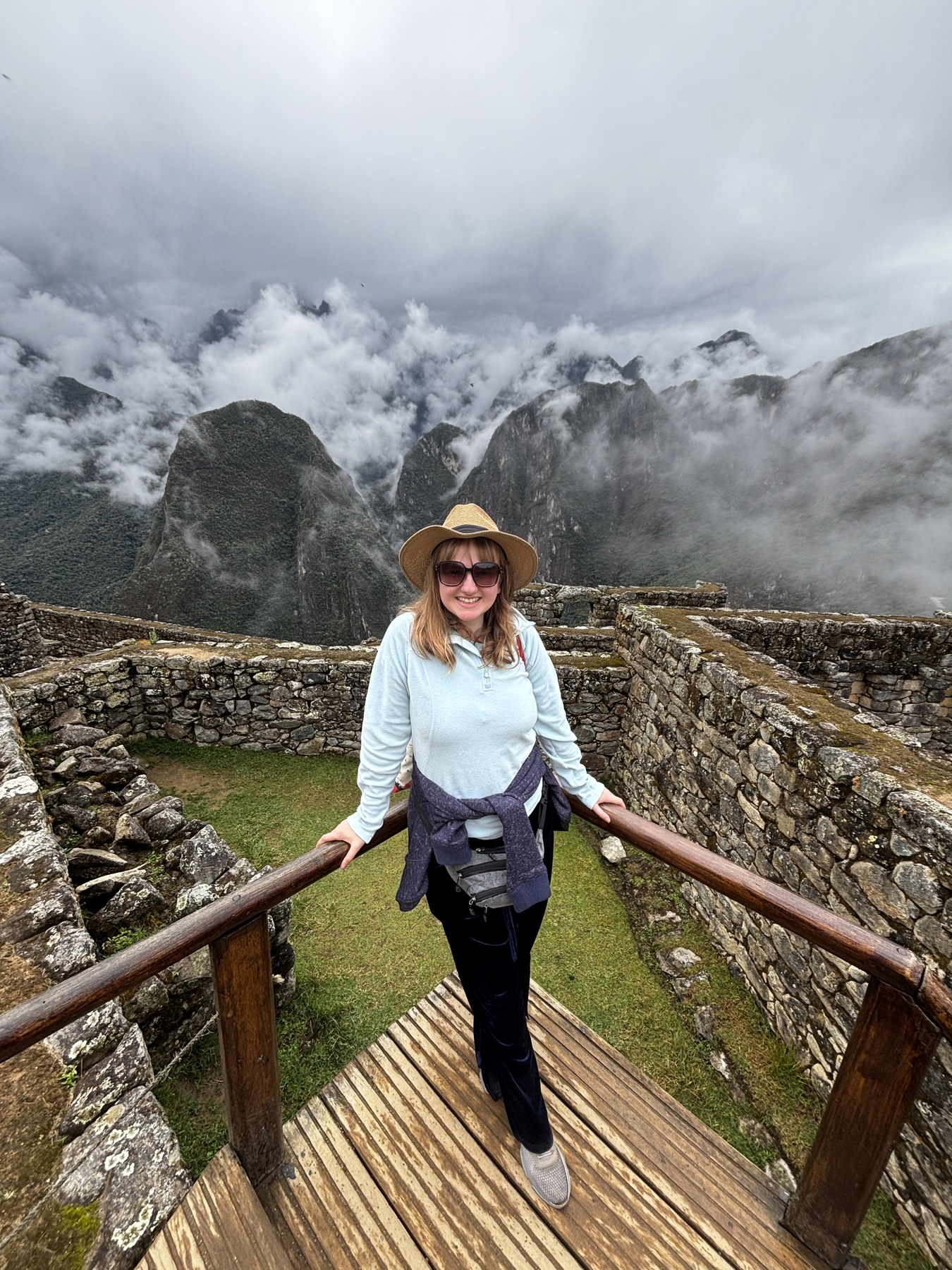 Georgia smiling among the mountain clouds at Machu Picchu