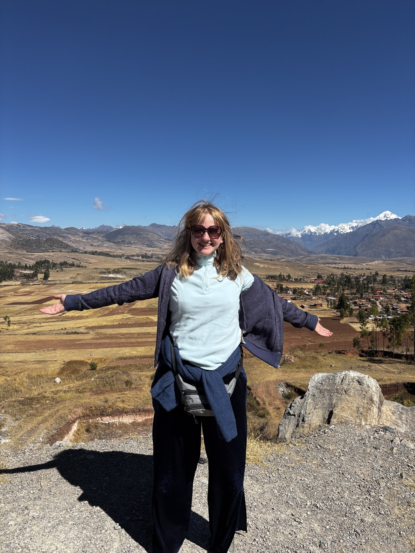 Georgia standing with open arms in Peru’s Sacred Valley